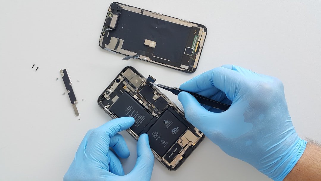 a-person-in-blue-gloves-is-repairing-a-cell-phone-6e3omj688nk